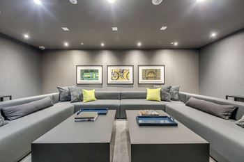 A modern living room with grey couches and a coffee table.